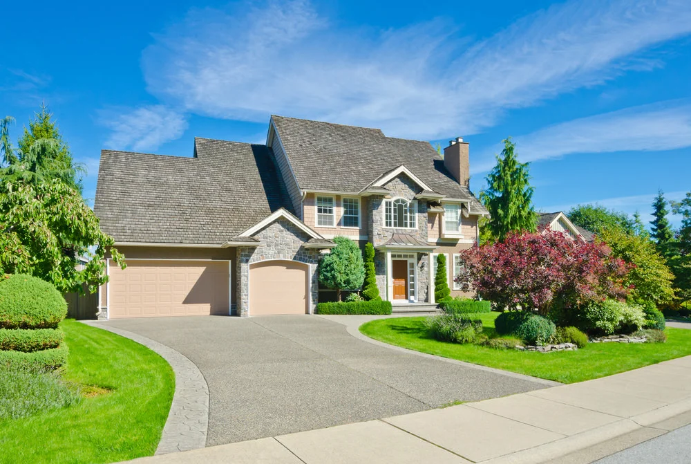 Two-story single-family rental home with stone and siding exterior in a US suburban neighborhood